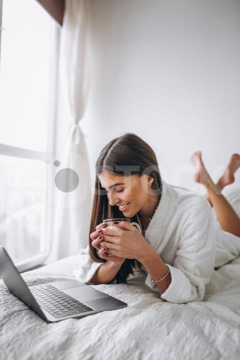 Young woman working computer bed 1303 13304 jpg