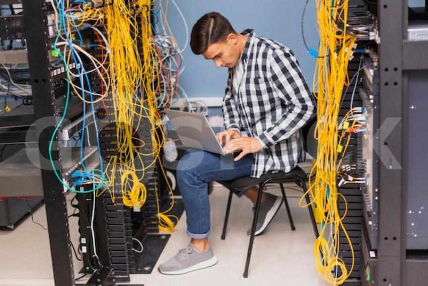 Network engineer with laptop long shot 23 2148323454 jpg